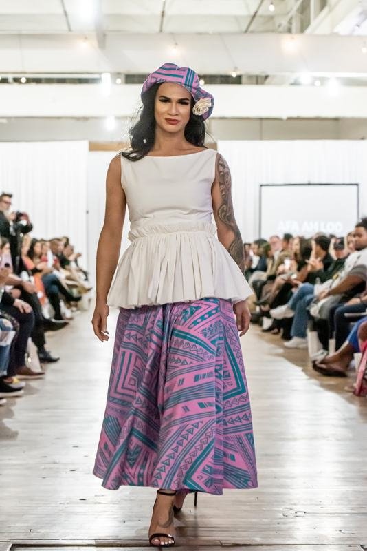 Model in a white top and patterned skirt at the 2022 show