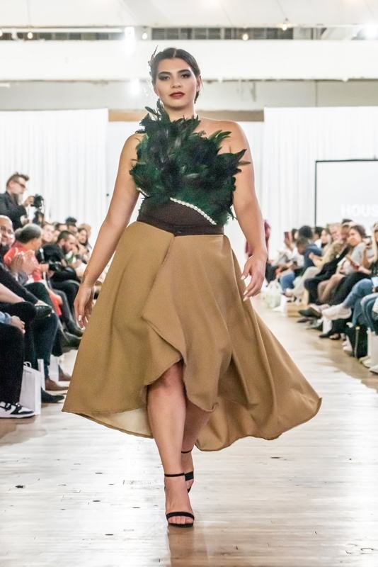 Model in a feathered top on the 2022 runway