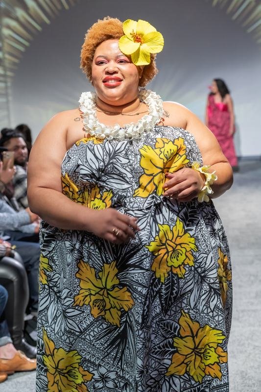 Model in a yellow floral dress at the 2023 Le Pasefika Runway show