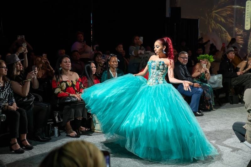 Model in a teal ballgown on the 2023 runway