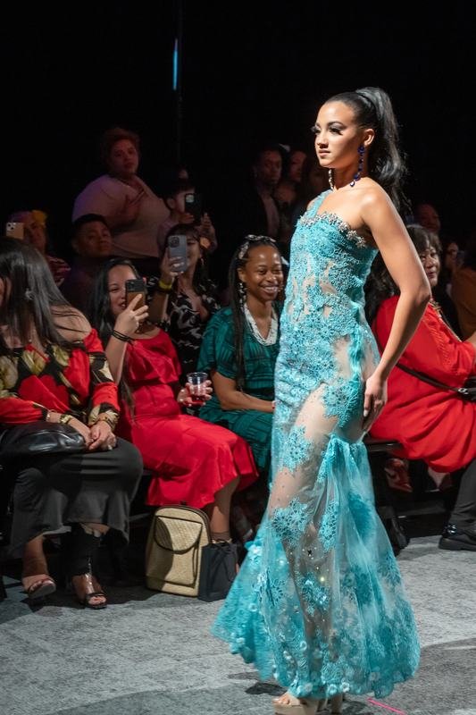 Model in a teal lace gown at the 2023 show