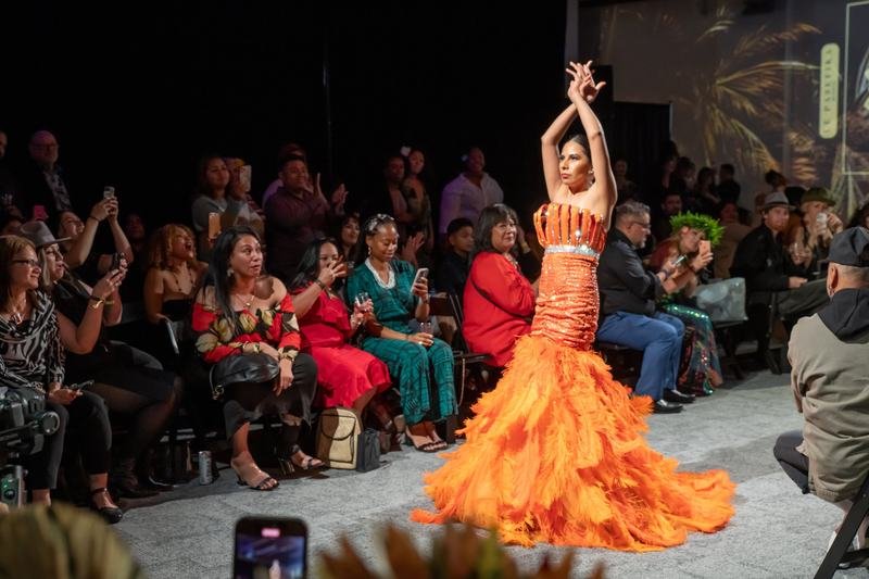 Model in an orange feathered gown at the 2023 show