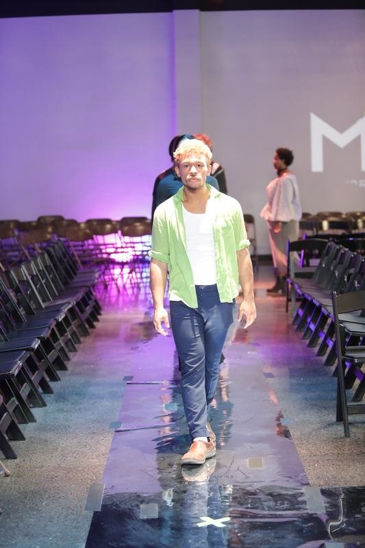 Model striking a pose on the runway at Le Pasefika Runway 2025