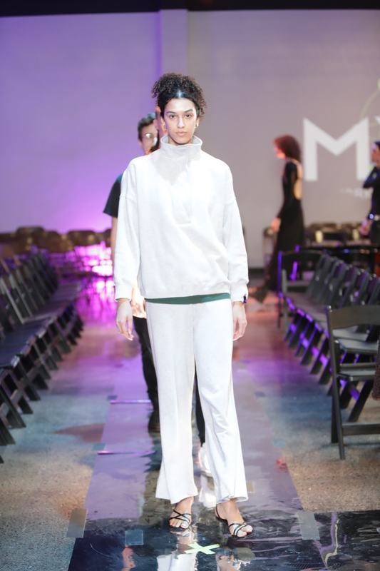 Model in white on the 2025 runway