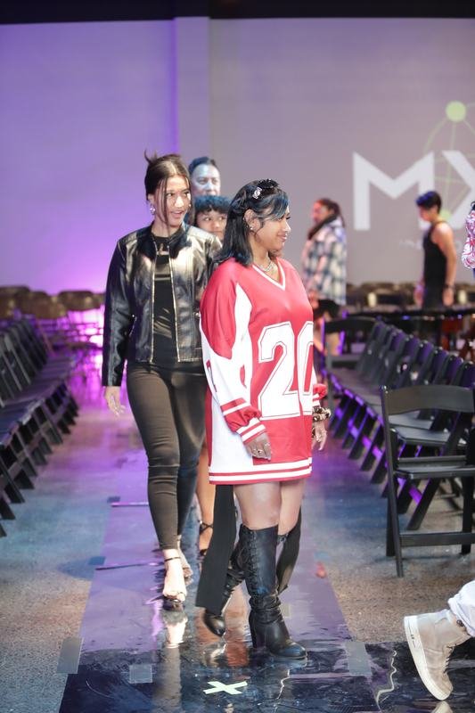 Model striking a pose on the runway at Le Pasefika Runway 2025